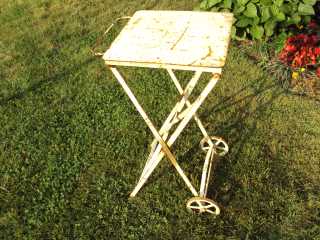 Outdoor metal table before applying Roof Menders gold coating