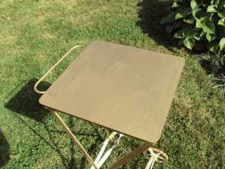 Table in shade showing Roof Menders' gold liquid paint